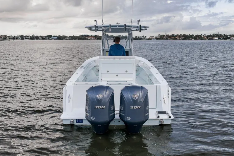 Slide: The Image of 2019 Contender 32 ST boat with dual Yamaha 300 engines on calm water. - 13