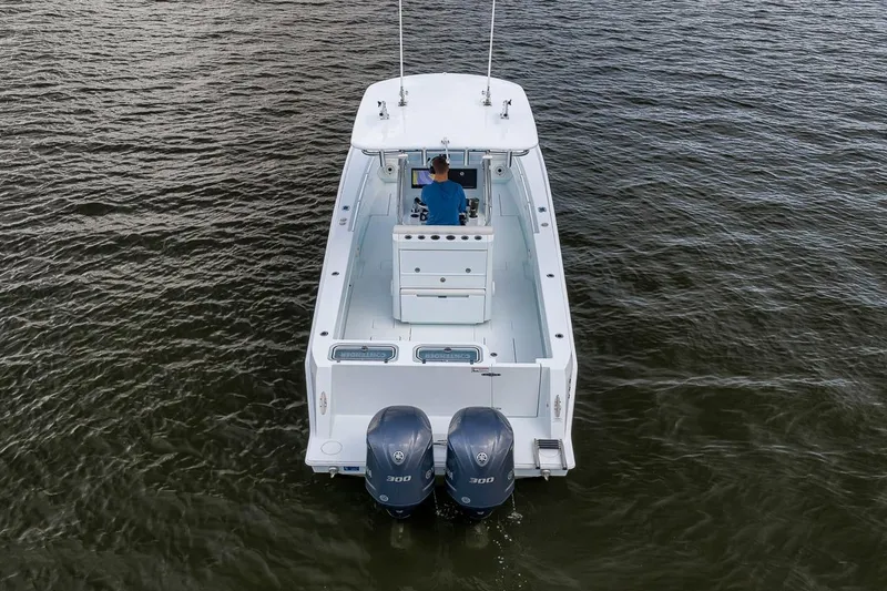 Slide: The Image of 2019 Contender 32 ST boat on water, rear view with dual engines. - 14