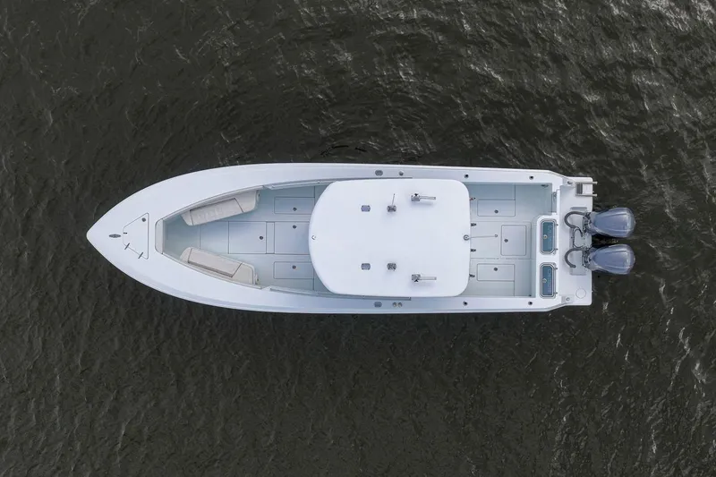 Slide: The Image of Aerial view of 2019 Contender 32 ST boat on water, showcasing sleek design and twin engines. - 16