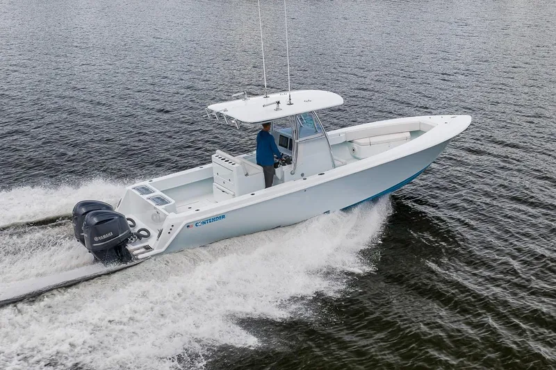 Slide: The Image of 2019 Contender 32 ST boat cruising on water with dual Yamaha engines. - 18