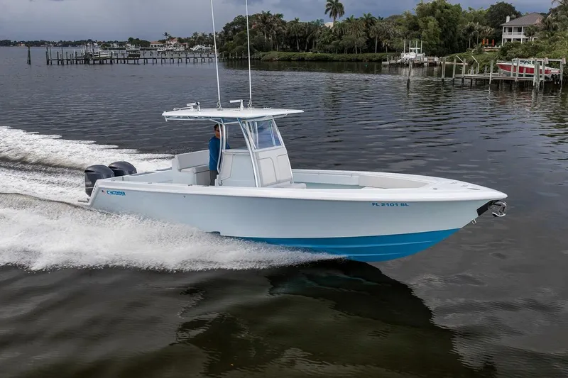 Slide: The Image of 2019 Contender 32 ST boat cruising on a calm river with scenic background. - 19