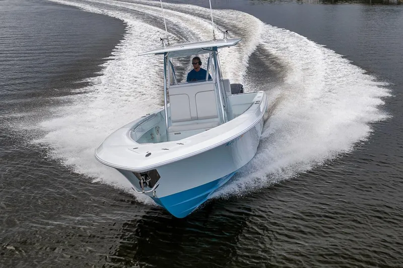 Slide: The Image of 2019 Contender 32 ST boat cruising swiftly on water, creating dynamic wake patterns. - 21