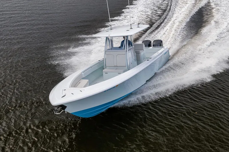 Slide: The Image of 2019 Contender 32 ST boat cruising swiftly on open water. - 22