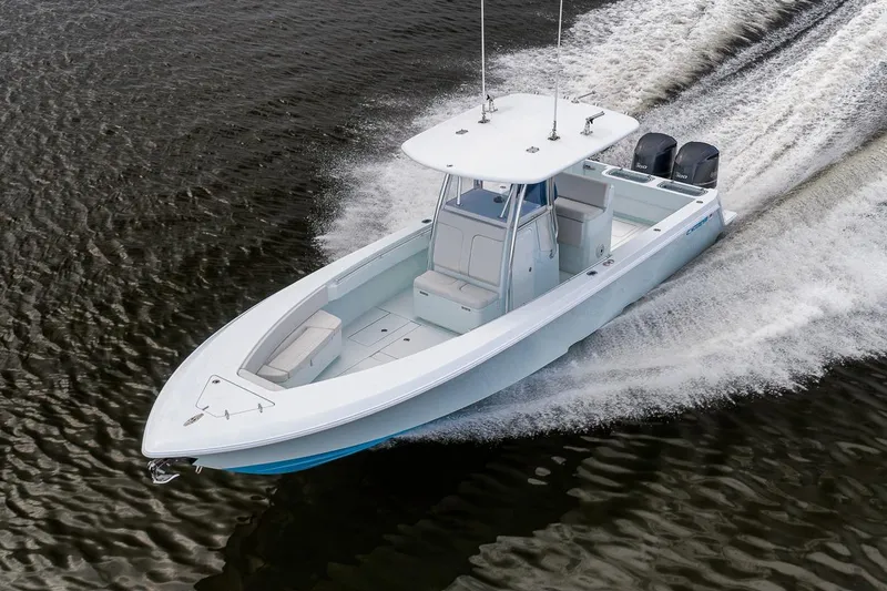 Slide: The Image of 2019 Contender 32 ST boat cruising on water with twin engines. - 24