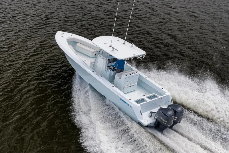 Slide: The Image of 2019 Contender 32 ST boat cruising on open water, rear view. - 25