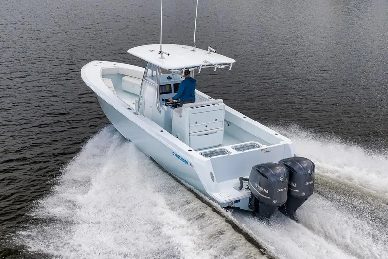 Slide: The Image of 2019 Contender 32 ST boat cruising on water with dual Yamaha engines. - 27