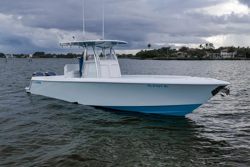 Slide: The Image of 2019 Contender 32 ST boat on water under cloudy sky. - 3