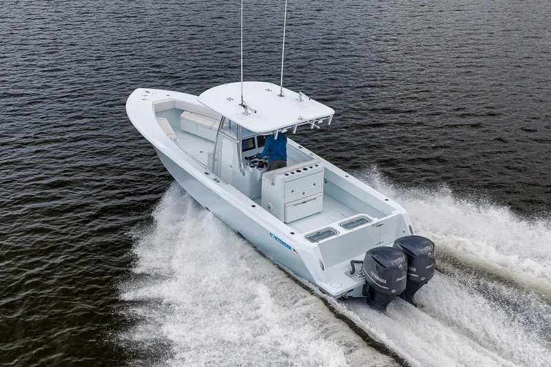 Slide: The Image of 2019 Contender 32 ST boat cruising on water with dual outboard engines. - 31
