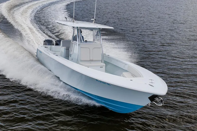 Slide: The Image of 2019 Contender 32 ST boat cruising on open water, showcasing sleek design and performance. - 35