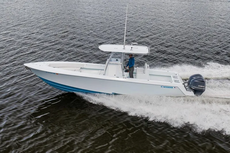 Slide: The Image of 2019 Contender 32 ST boat cruising on water with Yamaha engines. - 36