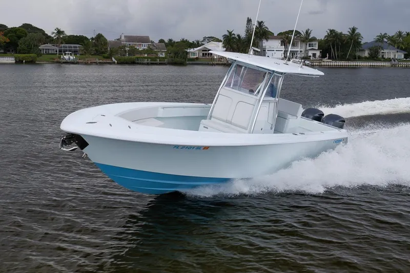 Slide: The Image of 2019 Contender 32 ST boat cruising on a scenic waterway. - 38