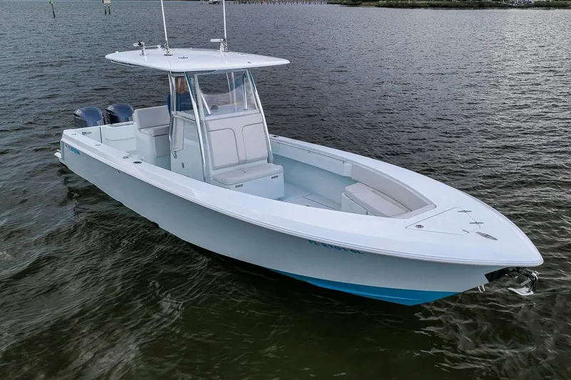 Slide: The Image of 2019 Contender 32 ST boat on calm water, featuring sleek design and twin engines. - 4