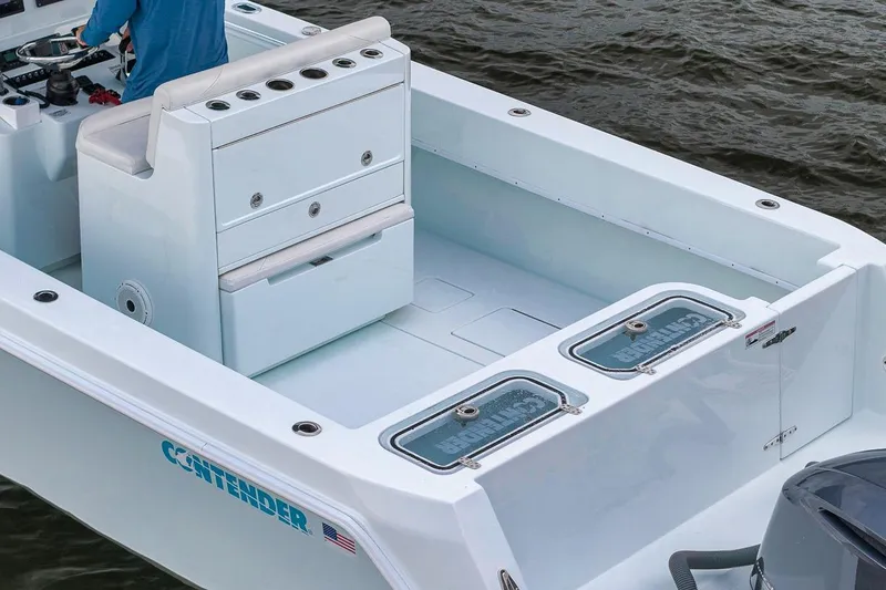 Slide: The Image of 2019 Contender 32 ST boat interior with seating and storage, on water. - 42