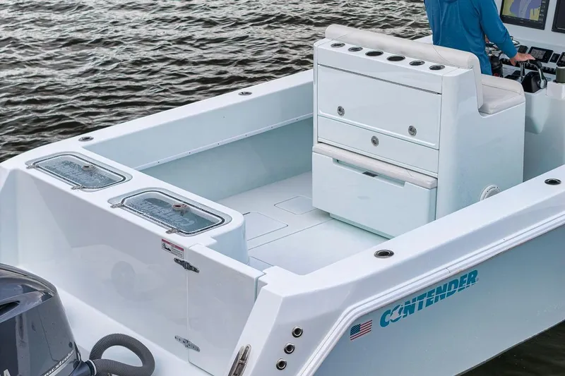 Slide: The Image of 2019 Contender 32 ST boat interior with storage and seating, on water. - 43