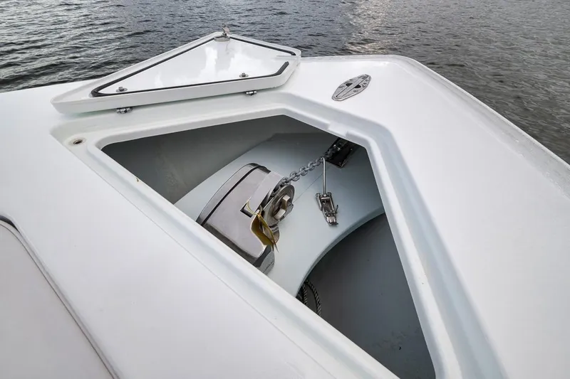 Slide: The Image of 2019 Contender 32 ST boat anchor compartment with chain, open hatch, and water view. - 47