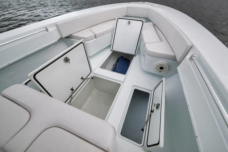 Slide: The Image of 2019 Contender 32 ST boat interior with open storage compartments and seating. - 48