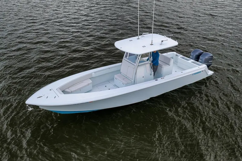 Slide: The Image of 2019 Contender 32 ST boat on water, featuring dual outboard engines. - 5