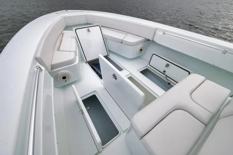 Slide: The Image of 2019 Contender 32 ST boat interior with open storage compartments and cushioned seating. - 50
