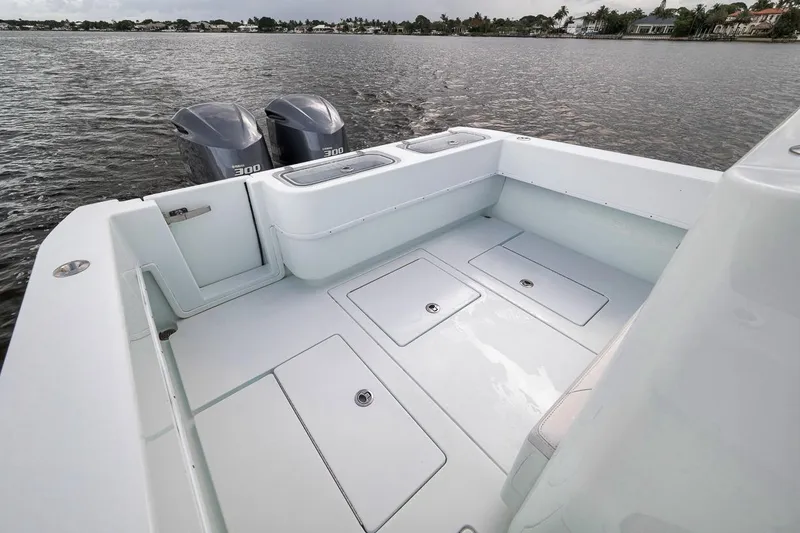 Slide: The Image of 2019 Contender 32 ST boat with dual engines on a calm waterway. - 51