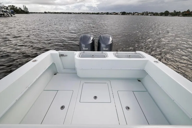 Slide: The Image of 2019 Contender 32 ST boat with dual 300 horsepower engines on a calm waterway. - 52