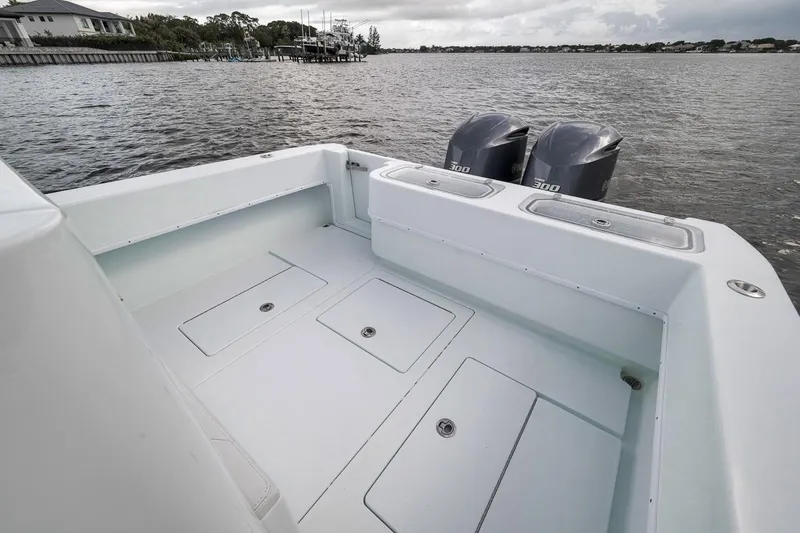 Slide: The Image of 2019 Contender 32 ST boat with dual engines on a calm waterway. - 53