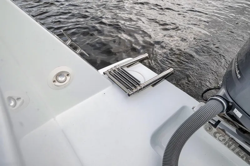 Slide: The Image of 2019 Contender 32 ST boat with ladder and motor on water. - 55