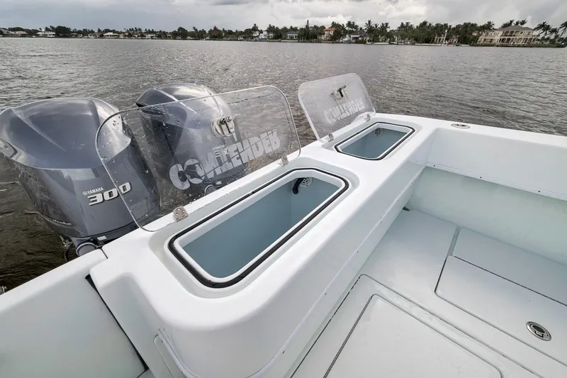 Slide: The Image of 2019 Contender 32 ST boat with Yamaha 300 engines on a calm lake. - 56
