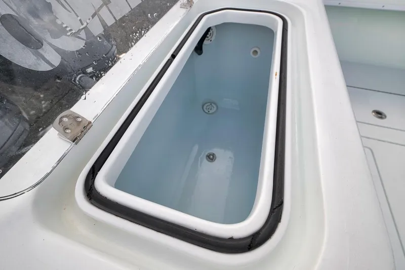 Slide: The Image of Livewell on 2019 Contender 32 ST boat, featuring a clean, white interior. - 57