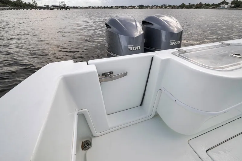 Slide: The Image of 2019 Contender 32 ST boat with twin Yamaha 300 engines on a calm waterway. - 59