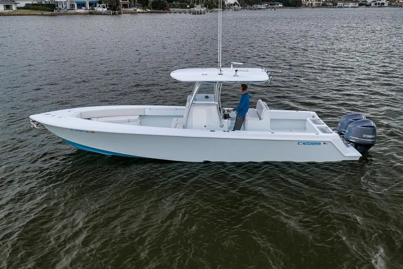 Slide: The Image of 2019 Contender 32 ST boat on water, featuring dual Yamaha engines and sleek design. - 6