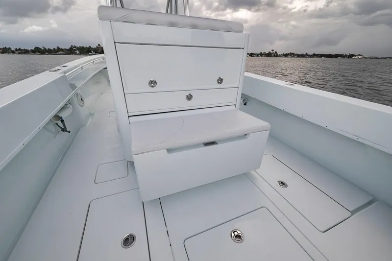 Slide: The Image of 2019 Contender 32 ST boat interior with storage compartments, on a calm water backdrop. - 62