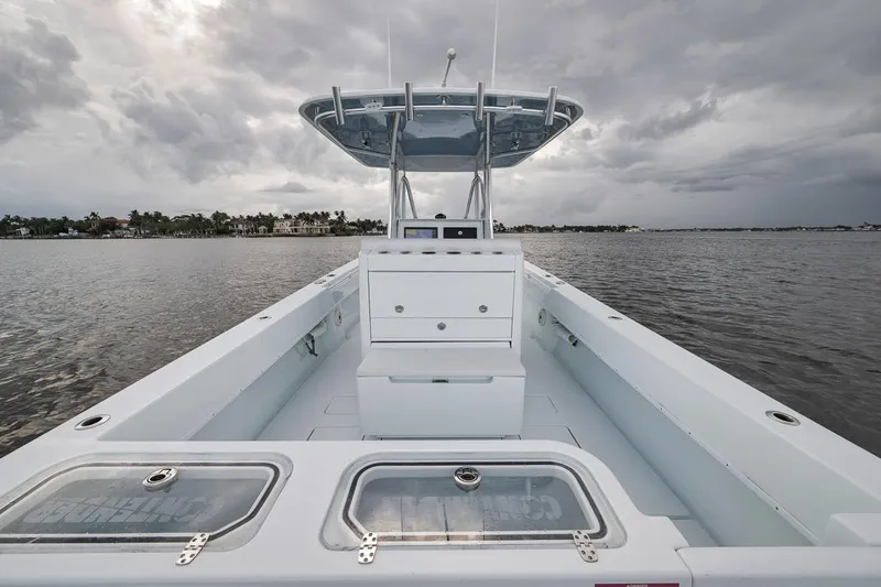 Slide: The Image of 2019 Contender 32 ST boat on calm water under cloudy skies. - 63