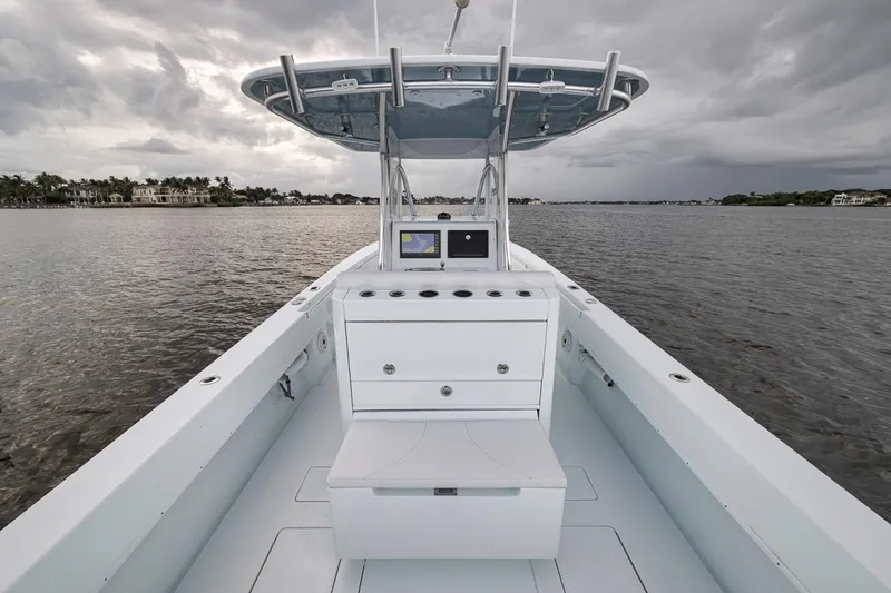 Slide: The Image of 2019 Contender 32 ST boat on water, featuring sleek design and modern console. - 64