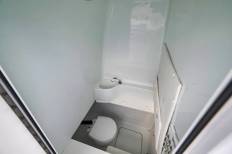 Slide: The Image of Compact marine bathroom in 2019 Contender 32 ST boat, featuring a toilet and sink. - 70
