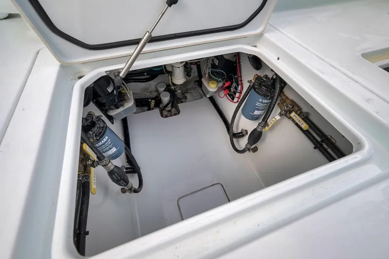 Slide: The Image of Open hatch of 2019 Contender 32 ST boat showing internal components and wiring. - 74