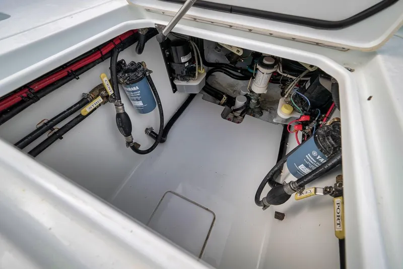 Slide: The Image of 2019 Contender 32 ST boat engine compartment with Yamaha filters and wiring. - 75