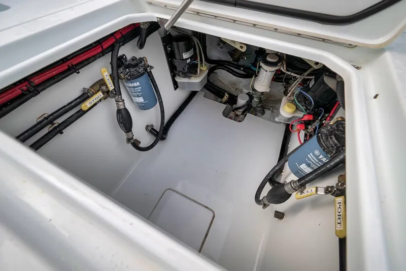 Slide: The Image of 2019 Contender 32 ST boat engine compartment with Yamaha filters and wiring. - 76
