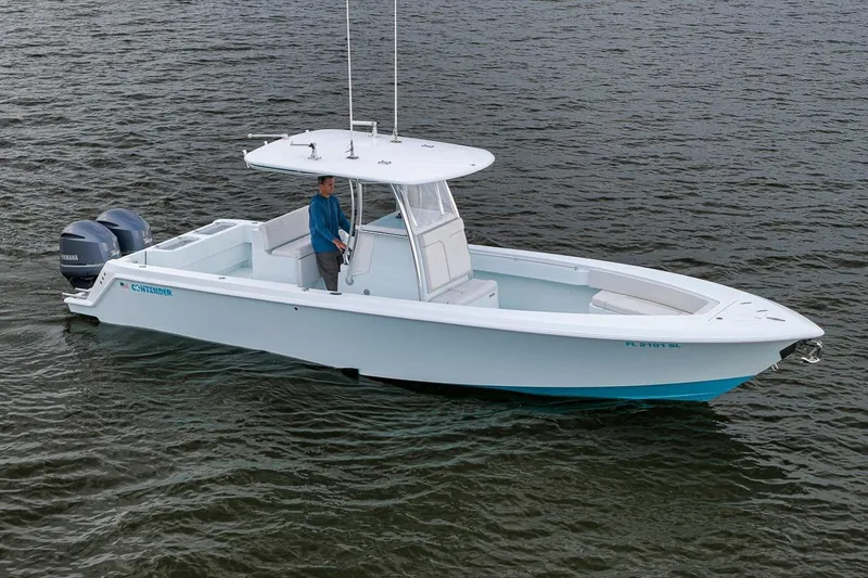 Slide: The Image of 2019 Contender 32 ST boat on water with dual Yamaha engines. - 9