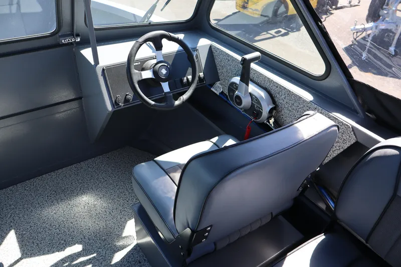 Slide: The Image of 2026 Alumaweld Talon 18 boat interior with steering wheel and control panel. - 16