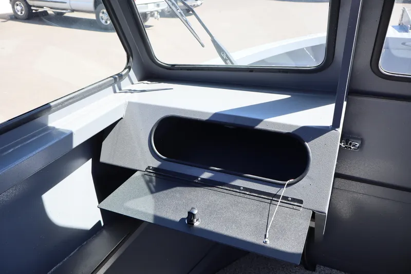 Slide: The Image of 2026 Alumaweld Talon 18 boat interior with open storage compartment and windows. - 19