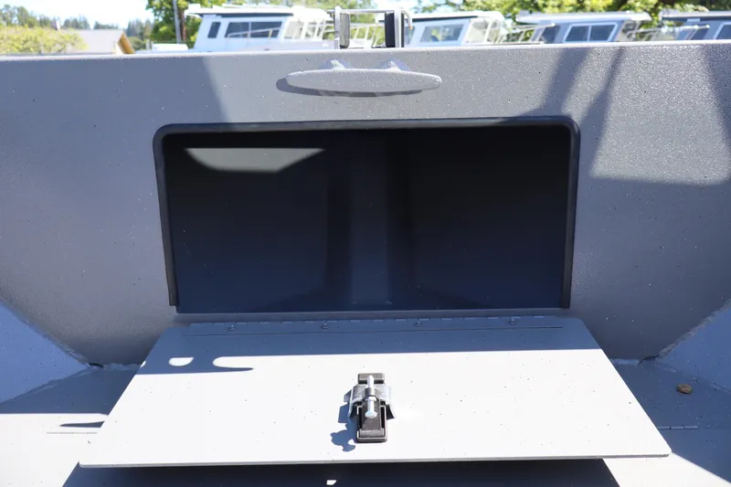Slide: The Image of Storage compartment on 2026 Alumaweld Talon 18 boat, open with latch visible. - 27