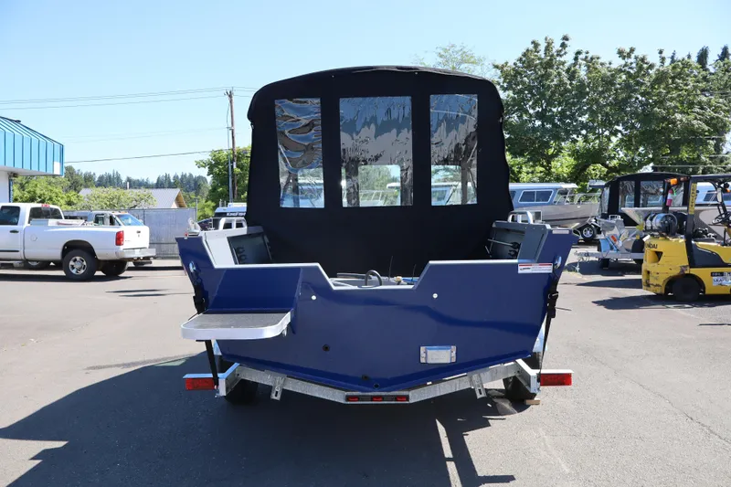 Slide: The Image of 2026 Alumaweld Talon 18 boat, rear view, parked outdoors on a sunny day. - 3