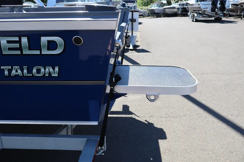 Slide: The Image of 2026 Alumaweld Talon 18 boat rear view with swim platform in a marina. - 5