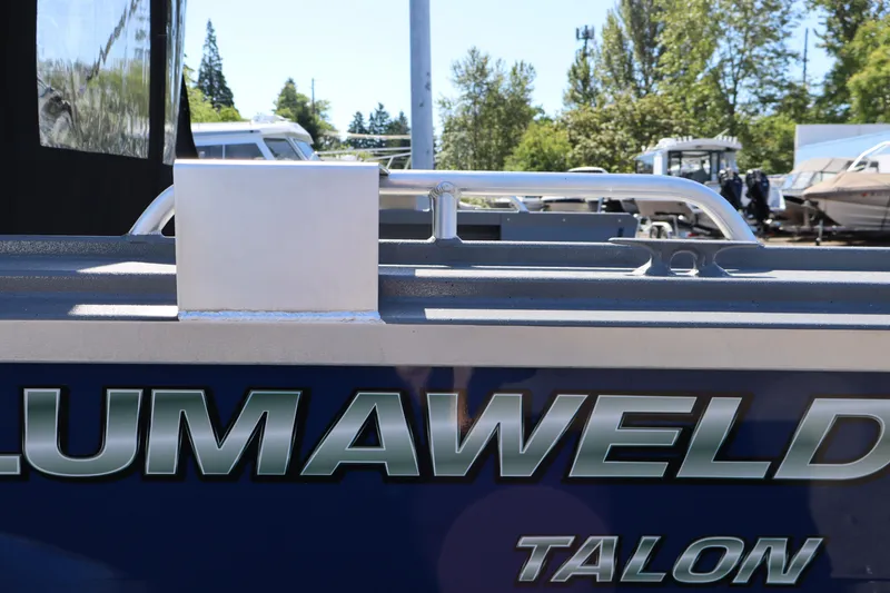 Slide: The Image of 2026 Alumaweld Talon 18 boat side view with logo in a marina setting. - 6