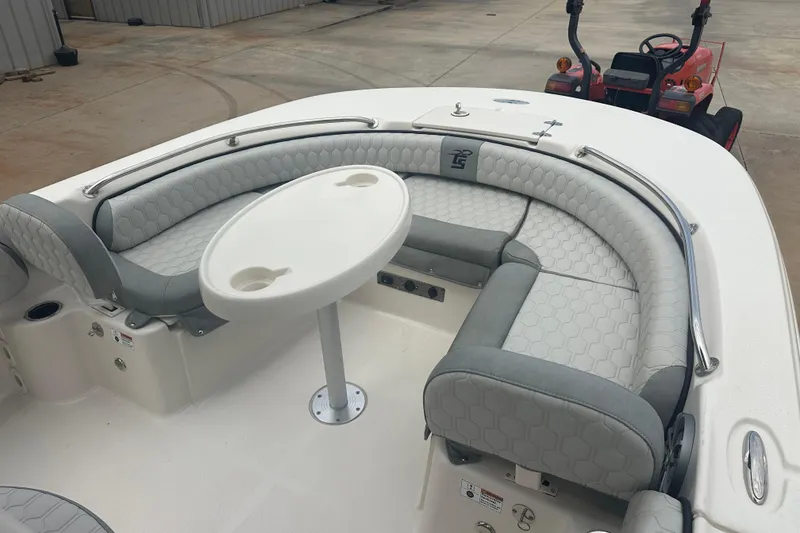 Slide: The Image of 2024 Carolina Skiff 21 Ultra Elite boat interior with cushioned seating and table. - 10