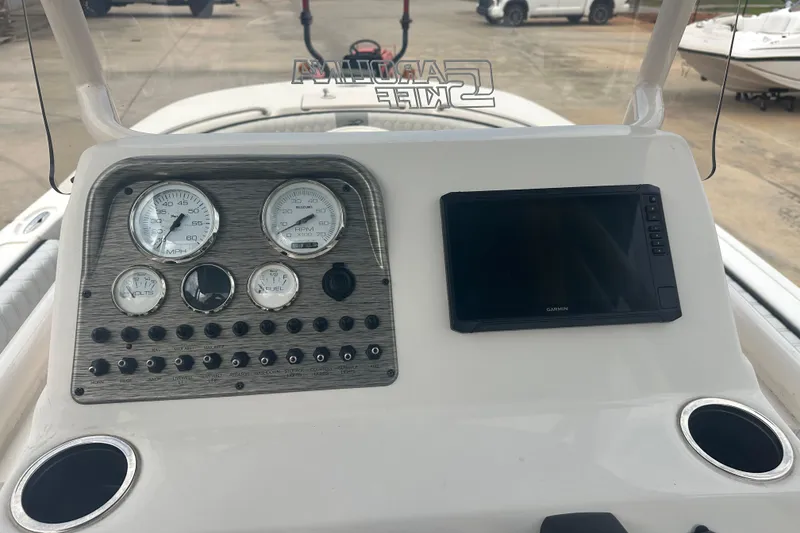 Slide: The Image of 2024 Carolina Skiff 21 Ultra Elite dashboard with gauges and Garmin display. - 13