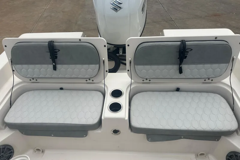 Slide: The Image of 2024 Carolina Skiff 21 Ultra Elite boat seats with cup holders and storage compartments. - 15