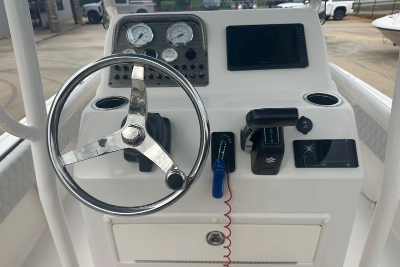 Slide: The Image of 2024 Carolina Skiff 21 Ultra Elite boat dashboard with steering wheel and controls. - 16