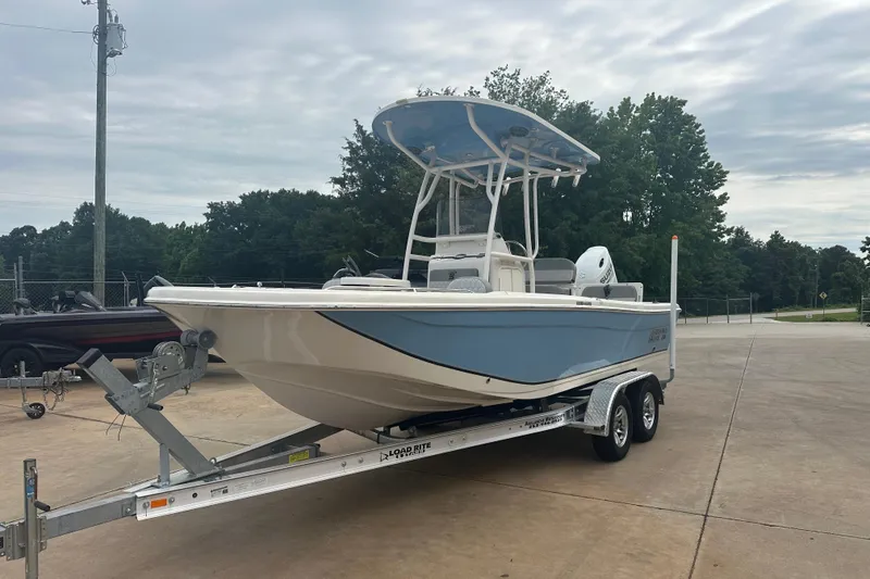 Slide: The Image of 2024 Carolina Skiff 21 Ultra Elite boat on trailer, parked outdoors. - 2