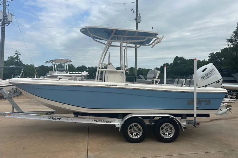Slide: The Image of 2024 Carolina Skiff 21 Ultra Elite boat on trailer, featuring Suzuki outboard motor. - 3